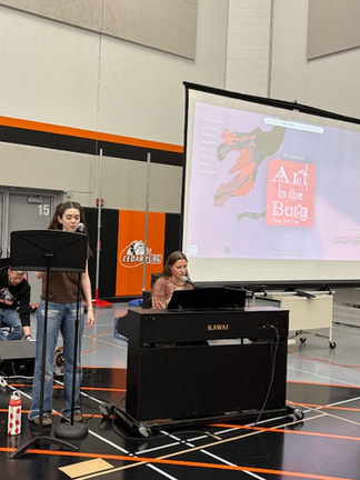 Students performing at piano during Art in the Burg